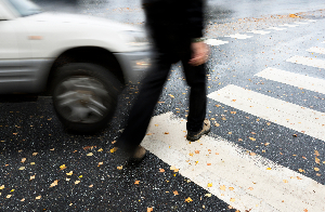 pedestrian using crosswalk getting hit by car.