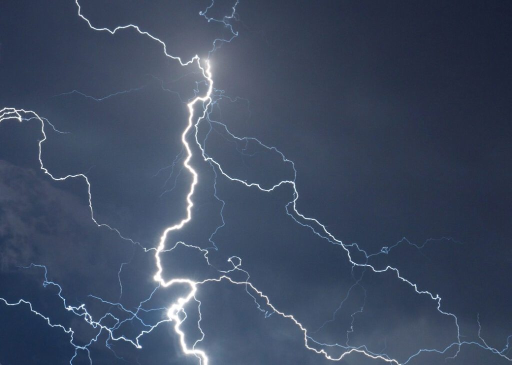 Fork lightning striking down during summer storm
