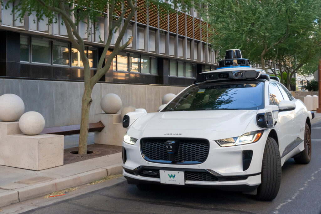 Phoenix, Arizona, USA - May 25, 2023: A Waymo’s self-driving Jaguar electric car on the road. Phoenix, Arizona, USA.