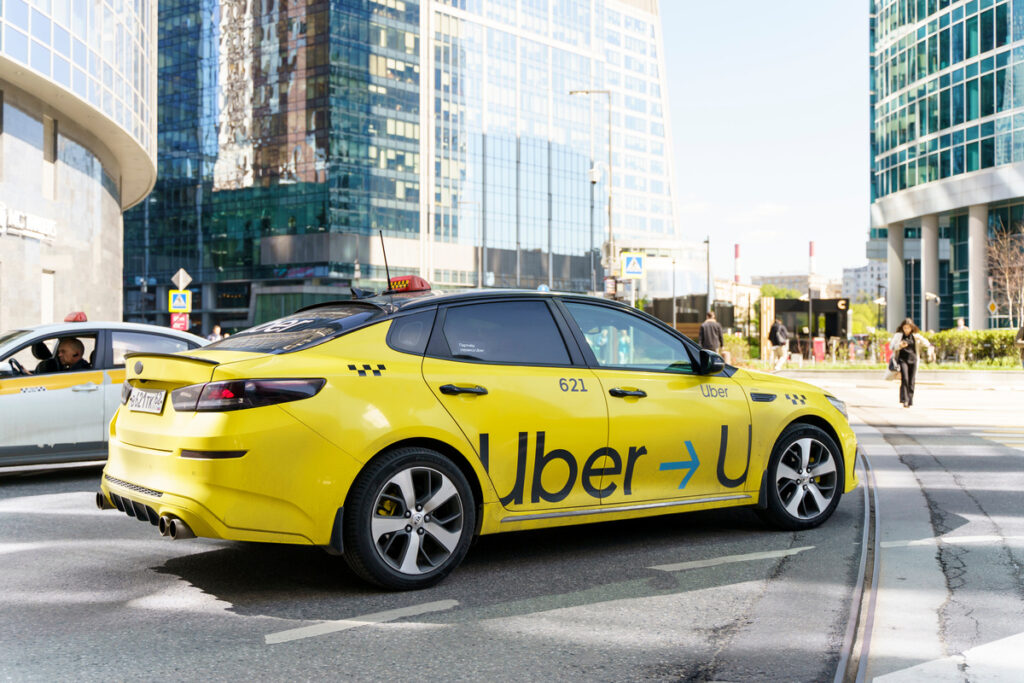 Uber Taxi car near Moscow International Business Center street, Moscow-City skyscrapers.