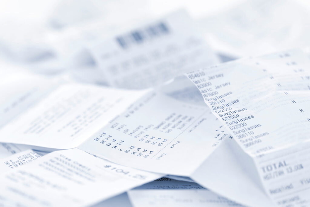 Paper cash register receipts in a lose pile close up