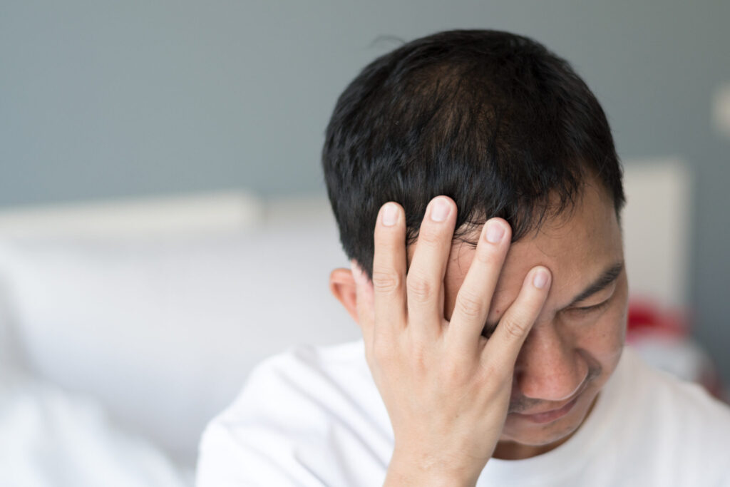 Migraine symptoms in businessman. Man suffering from pulsating pain of one sided headache. People medical healthcare concept