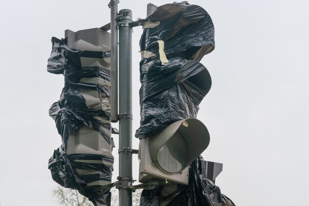 Old broken traffic light covered with film