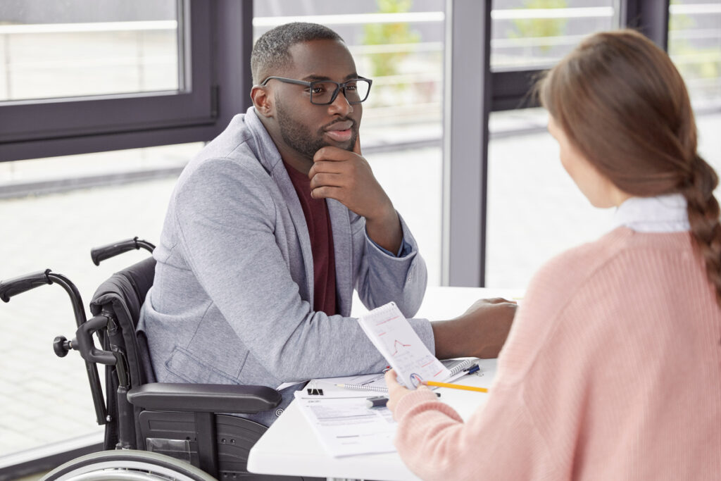 Male invalid involved in business activity, listens to female secretary who present annual report and new startup, suggests ways of canceling credit, believe in earning capacity and success.