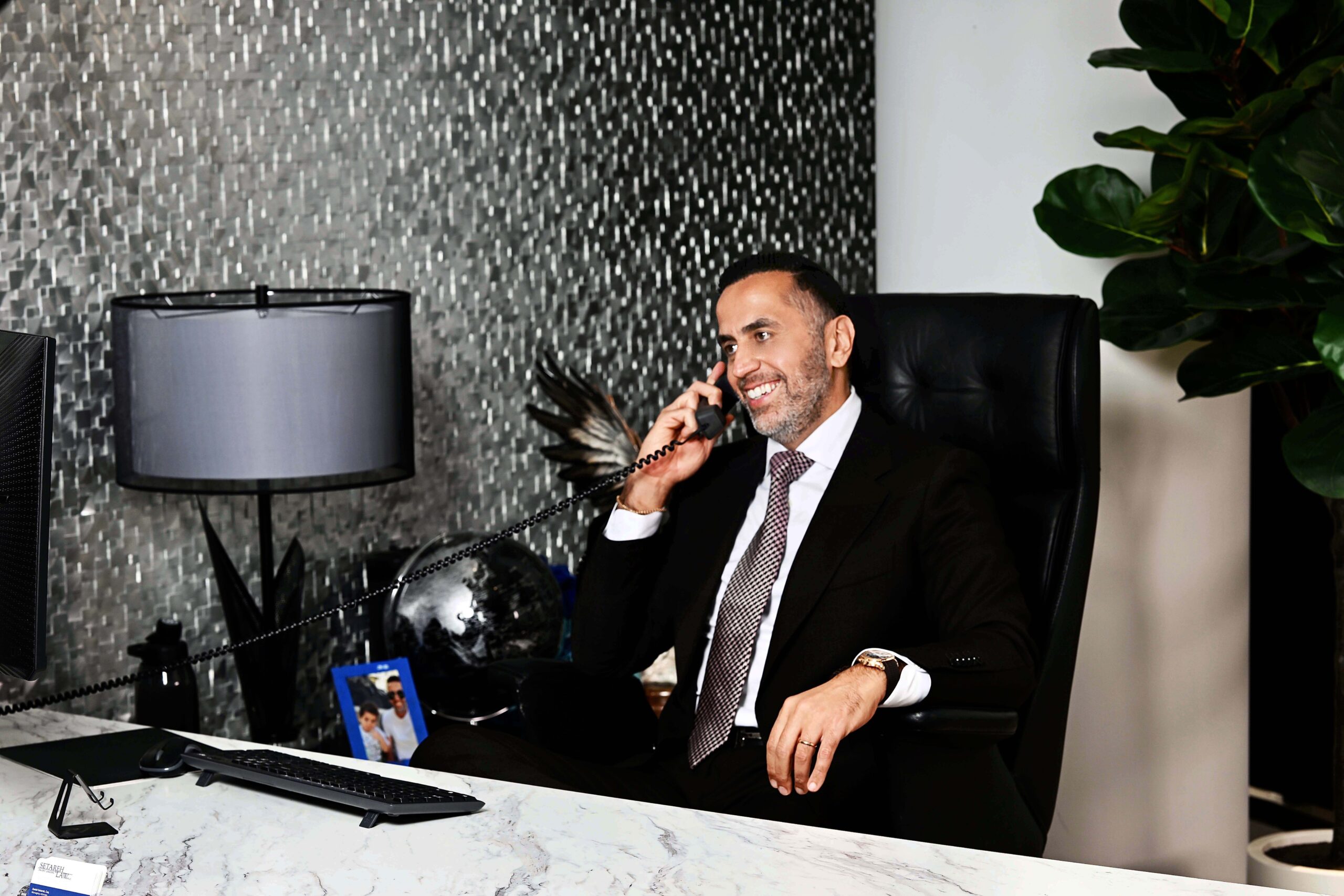 Daniel Setareh personal injury attorney at desk on phone in Beverly Hills office