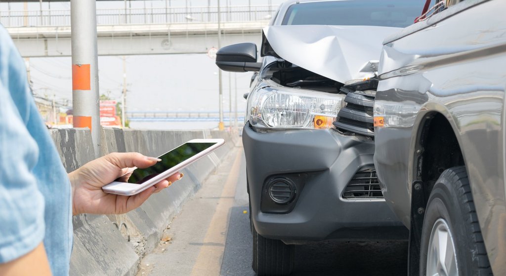 Driver exchanging insurance information after a car accident