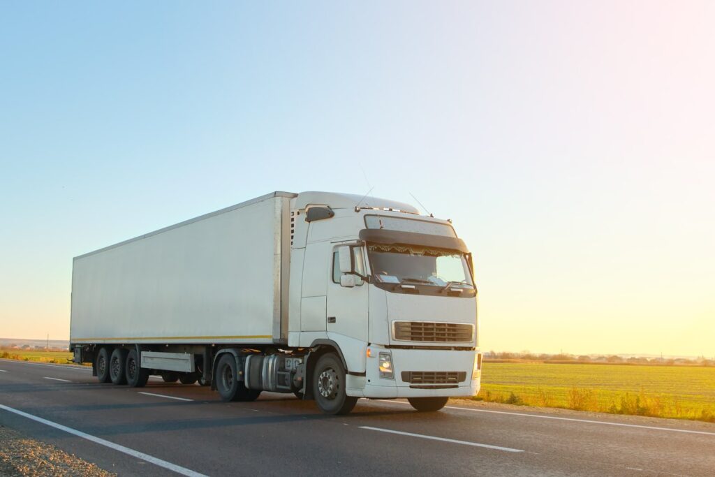 Semi-truck hauling cargo on a highway, representing an unsecured load vehicle accident case