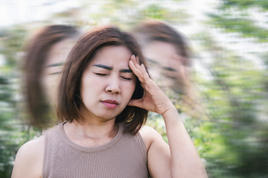 Woman experiencing dizziness and vertigo symptoms after a car accident