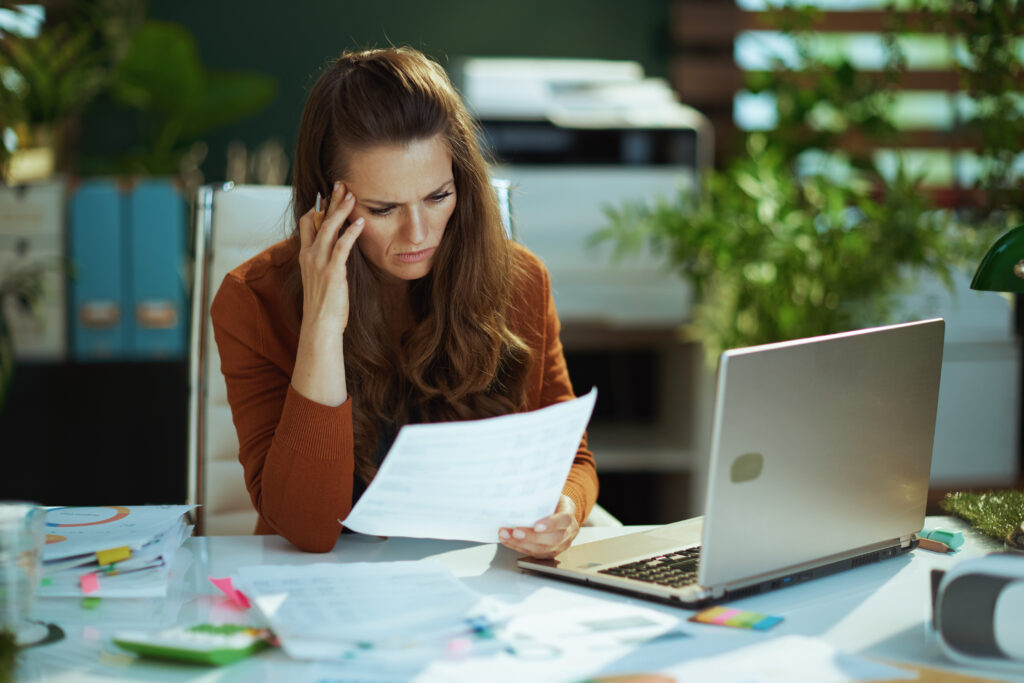 Self-employed business owner reviewing financial documents after a car accident